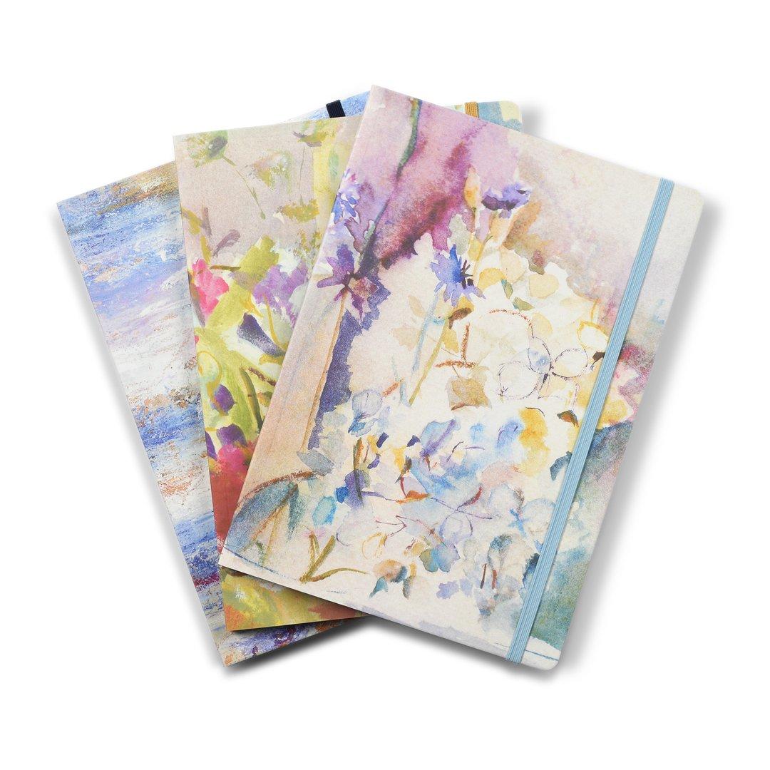 A collection of artistic notebooks made from original art by Judi Glover Art. Each arty notebook measures A5 with floral notebooks and seascape notebooks in the collection