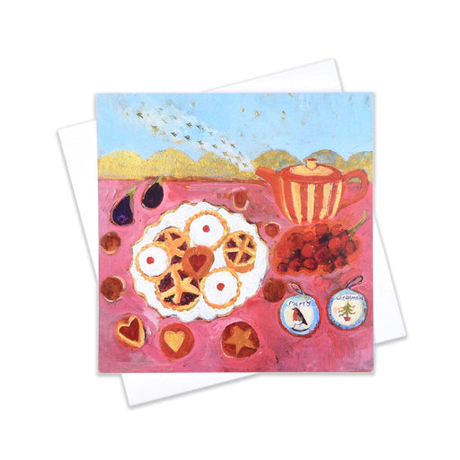 A joyful Christmas card with mince pie and cake illustrations and a teapot on a pink background