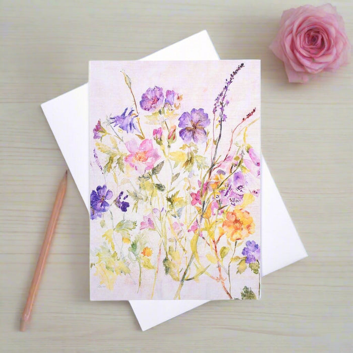 An all occasion greeting card of a watercolour painting of wildflowers which would make a good card for gardeners. The blank floral card shows colourful pansies and foxgloves.