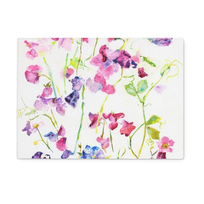 A glass chopping board with a watercolour of sweet peas design on the front. Perfect as a worktop saver or kitchen gift