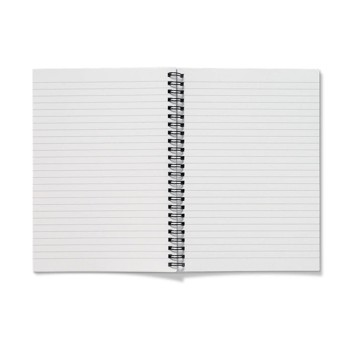 An A4 lined notebook with a cover of garden flowers such as pansies and cowslips