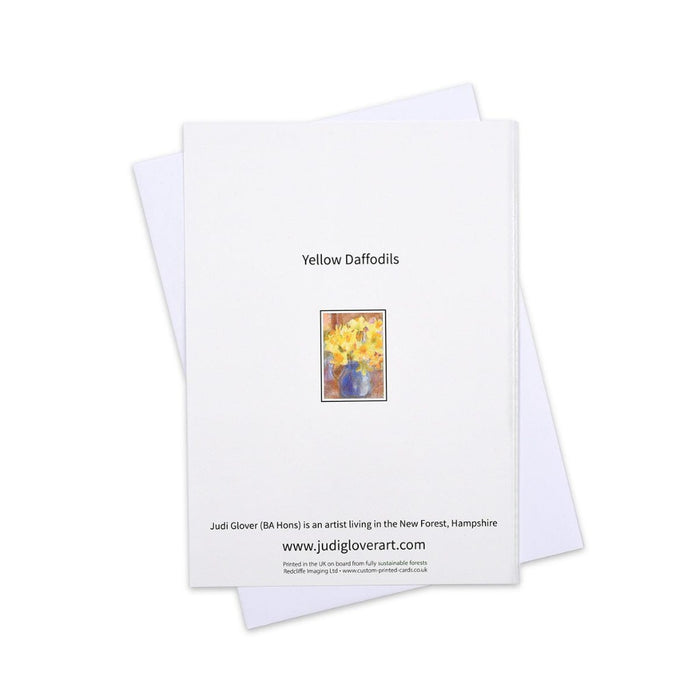 An art greeting card of a happy bunch of daffodils in a blue vase. This special card is blank inside for your own message