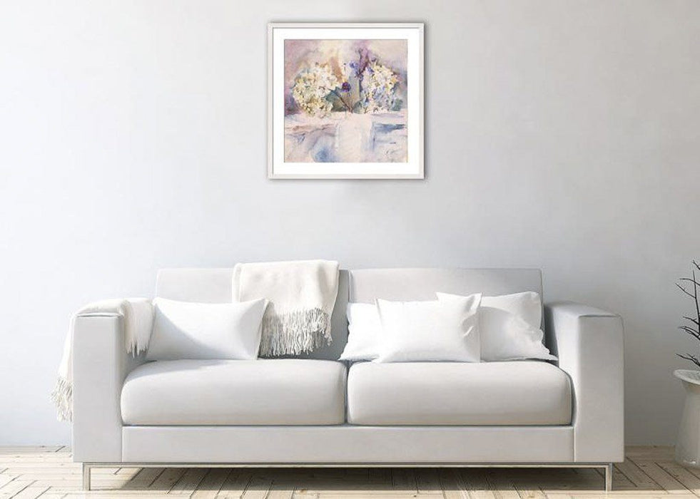 Hydrangea art print by Judi Glover Art shown framed in light grey on a wall above a sofa. The hydrangea print is from paintings by Judi Glover. Each flower print is printed on giclee paper in the UK by hand