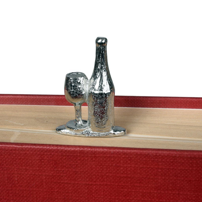 Gift for wine lovers by Judi Glover Art. The metal bookmark with a bottle of wine and a glass sits in a closed book