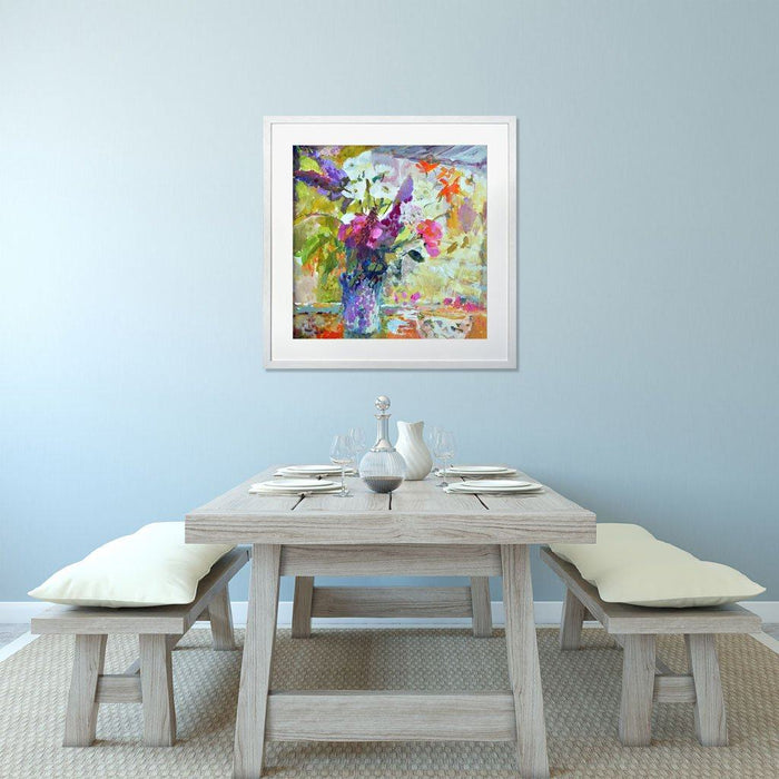 Showing the flower wall art of buddleia, sweet peas and daisies by Judi Glover Art hanging on a wall above a table and chairs. Each floral art print is printed on giclee paper and is available framed