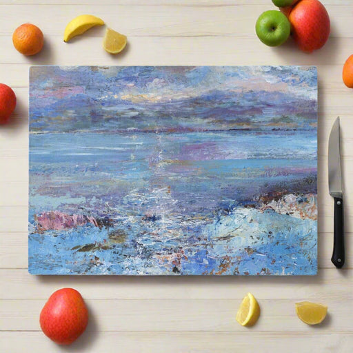 A glass chopping board and worktop saver featuring a seascape of the Isle of Mull with blue colours of the sea. The worktop protector will add a elegance to kitchen countertops and sideboards and is a coastal fine art piece