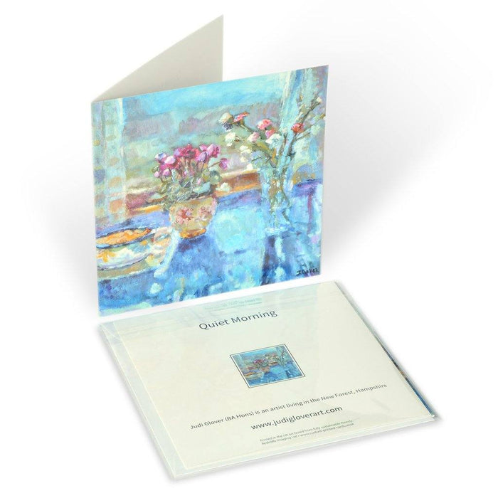 Showing the back of the fine art greeting card by Judi Glover Art. The artistic greeting cards shows a still life of flowers and a quiet morning. A blank card.