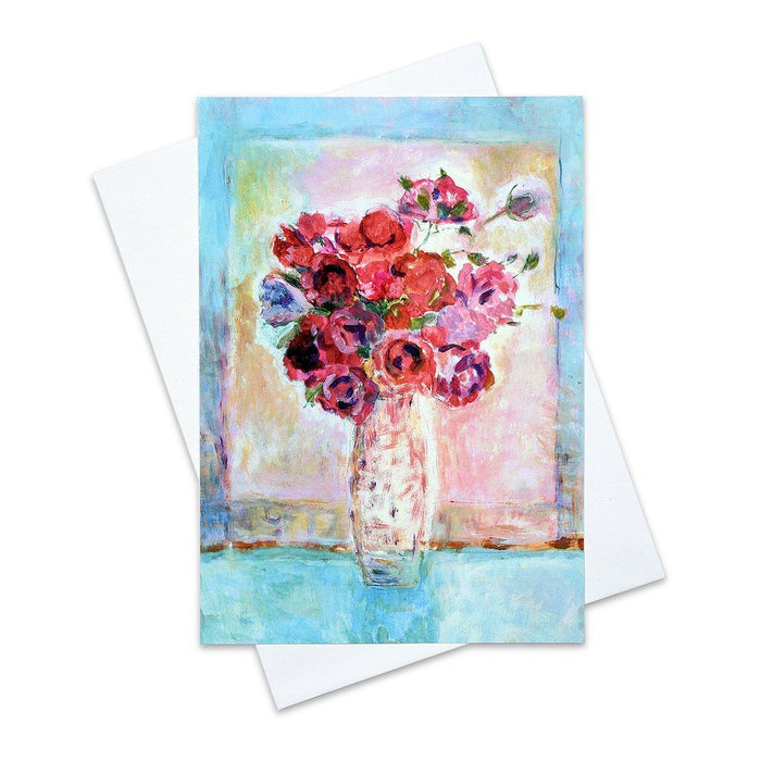 A pretty greeting card of red roses in a vase placed on pale blue table. This red roses card makes a special card for any occasion.