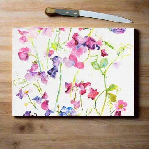 This pretty glass chopping board is hard wearing, versatile and made from a painting of sweet peas. The floral delicate pattern by Judi Glover Art makes a decorative worktop saver or kitchen gift and is made by glass experts from durable, toughened glass