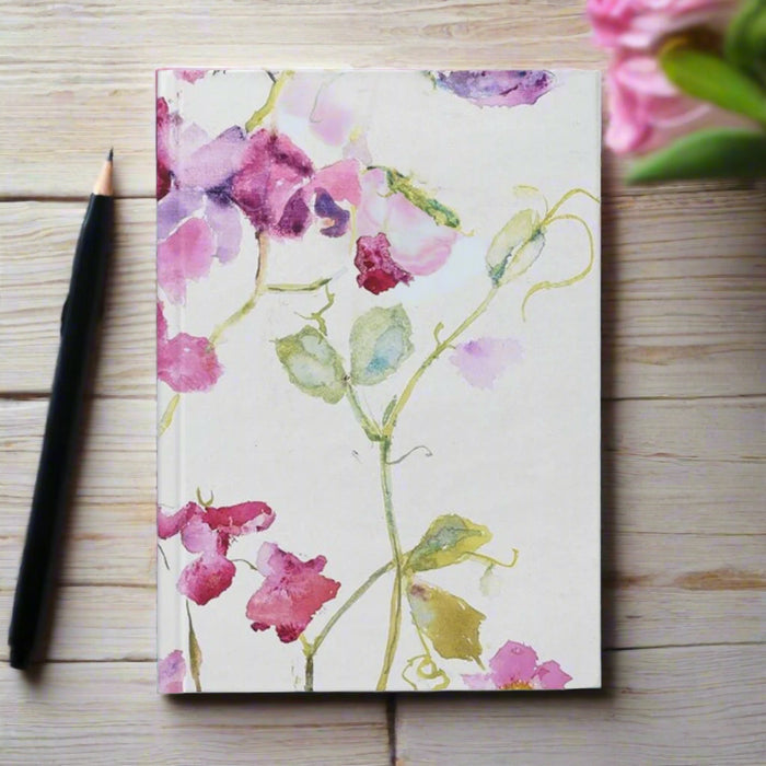 Hardback notebook journal featuring a floral design of delicate sweet peas. The A5 notebook journal is available as a lined notebook or plain notebook