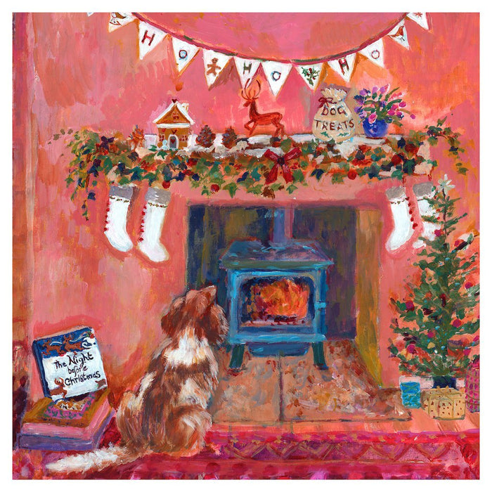 Christmas decor and Christmas print by Judi Glover Art showing a spaniel sitting by the fireplace on the night before Christmas. The Christmas wall art shows stockings, gingerbread house and ivy