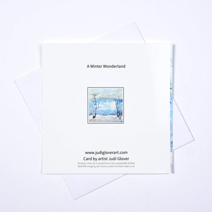 Back of A Winter Wonderland Christmas card with white envelope, artwork thumbnail and Judi Glover’s details