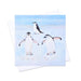 A Christmas card featuring three penguins playing in the snow which is part of a set of 6 bird Christmas cards