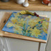 Toughened glass worktop saver used as a food serving platter or as a glass chopping board.  A pretty blue and yellow daffodil design makes this a perfect housewarming gift