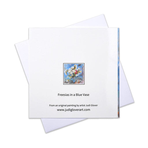 A floral greeting card made from an original painting of white freesias in a blue vase mking a beautiful card perfect for most occasions