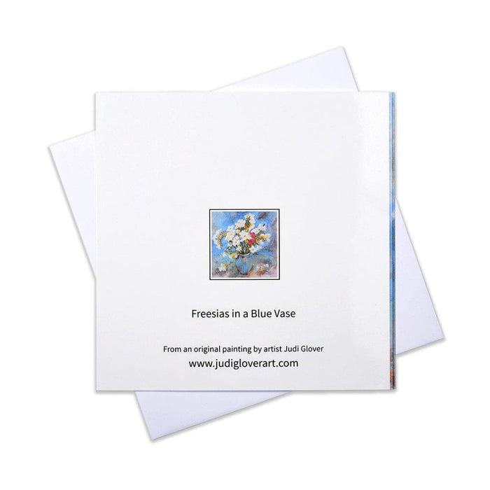 A floral greeting card made from an original painting of white freesias in a blue vase mking a beautiful card perfect for most occasions