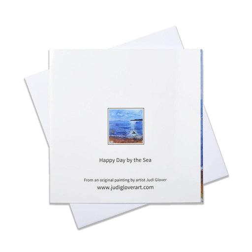 A seaside greeting card of a painting of a beach as a little dog splashes in the sea. This blank art card is perfct for most occasions