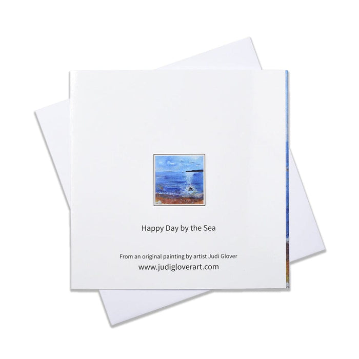 A seaside greeting card of a painting of a beach as a little dog splashes in the sea. This blank art card is perfct for most occasions