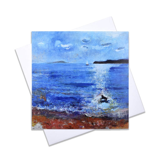 A blank art card of a seaside painting of a sweet little dog playing in the sea with a background of an island and a yacht