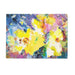 A glass chopping board with a beautiful abstract yellow and blue  design of vibrant daffodils. This worktop saver is made from toughened glass and is a perfect gift for a kitchen