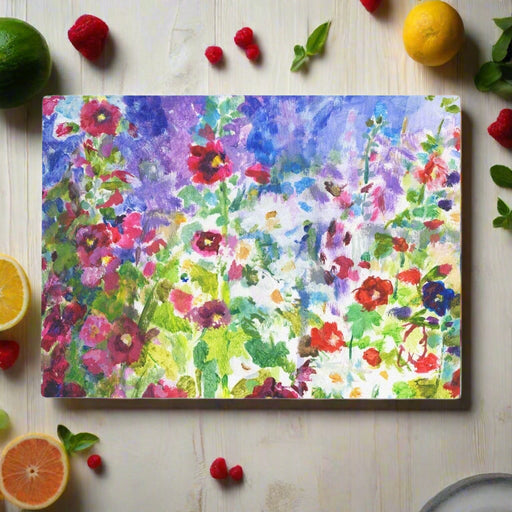 A toughened glass chopping board with a design of hollyhocks and daisies. This glass worktop protector is heat resistant so can be used as a serving platter for dishes from oven to table or as a glass cheeseboard