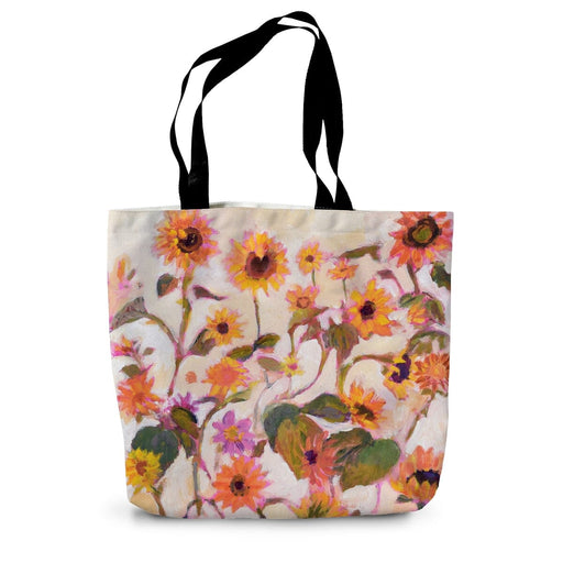 A canvas tote bag with a print of bright sunflowers on both sides