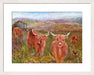 Highland cows print framed in white available at www.judigloverart.com. The Highland cow art shows Highland cattle in a field and is printed from a painting by Judi Glover