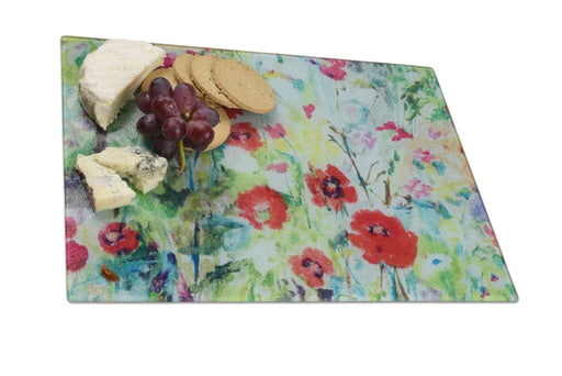 glass chopping board showing poppies with colours of red and green. The worktop saver by judi glover art would make a colourful housewarming present