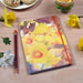 Daffodils notebook on a table with daffodils. The floral notebook has a beautiful cover made from a painting by Judi Glover Art