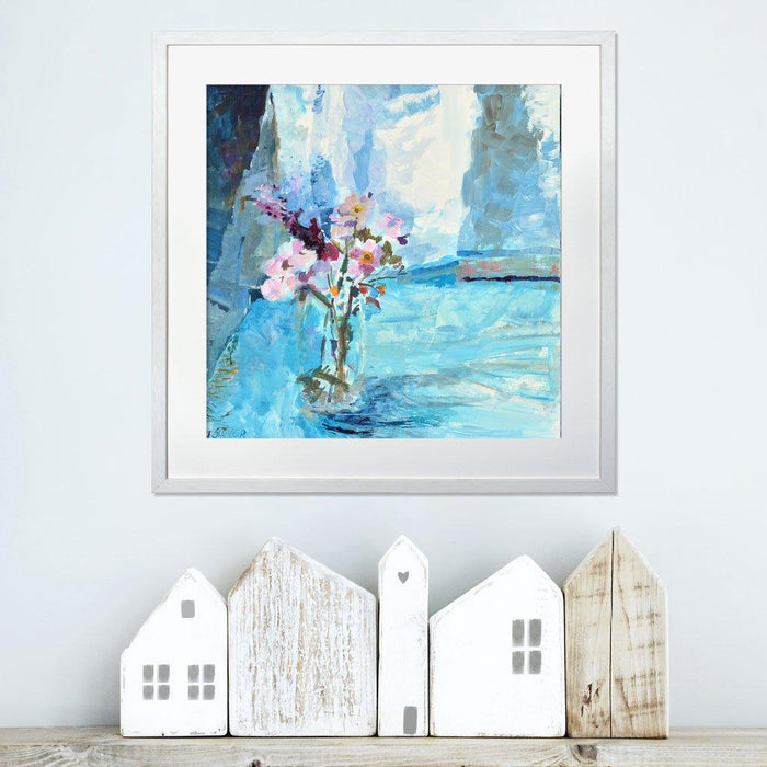 Wildflower Prints from a fine art painting of wildflowers surrounded by blue light by Judi Glover Art. The Flower Wall Art is printed on giclee paper and in a frame on a white wall above a shelf